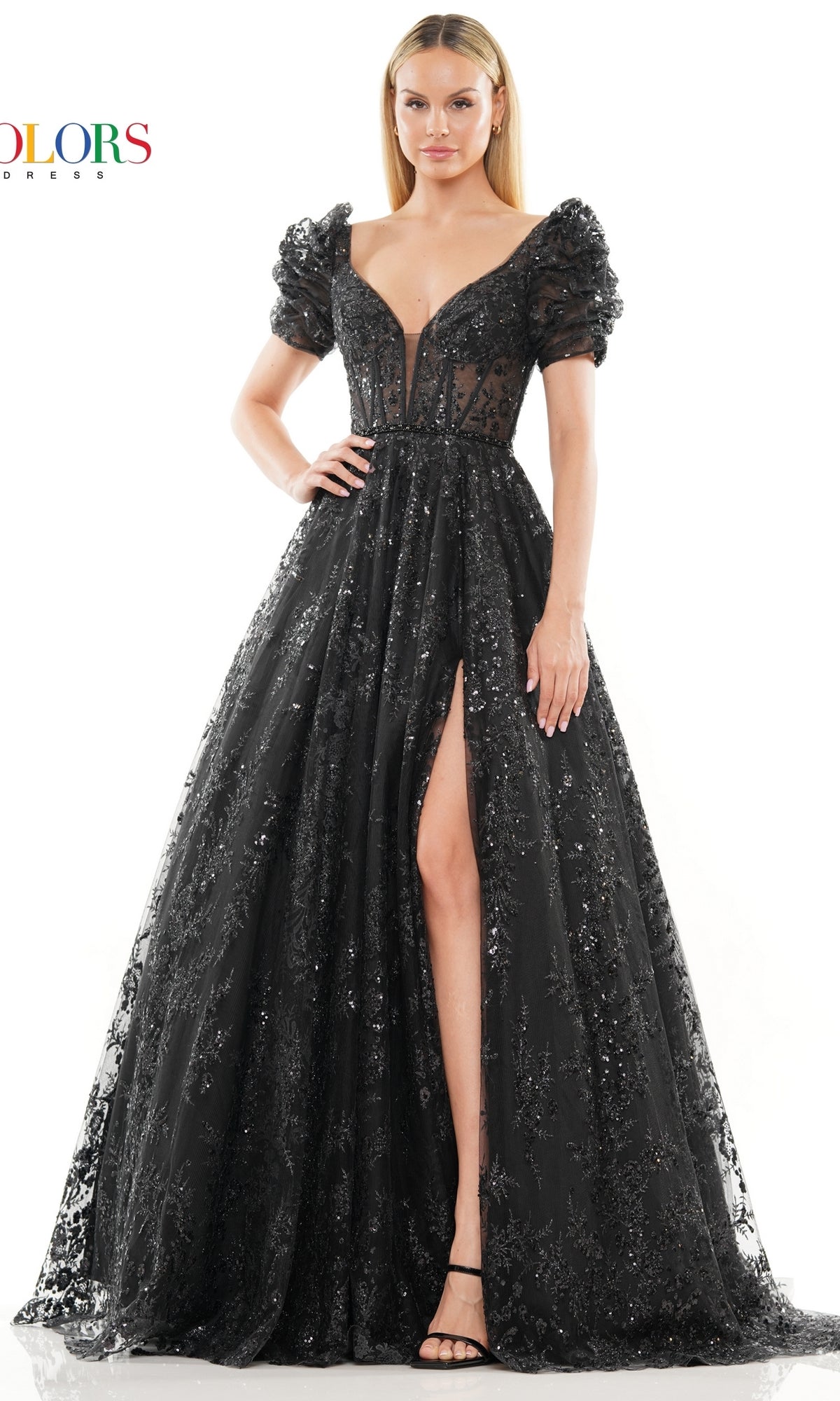A woman models the Short-Sleeve Long Glitter A-Line Prom Dress 3243, featuring black sequins, puffed short sleeves, a deep V-neckline, and a high slit, standing against a white background.